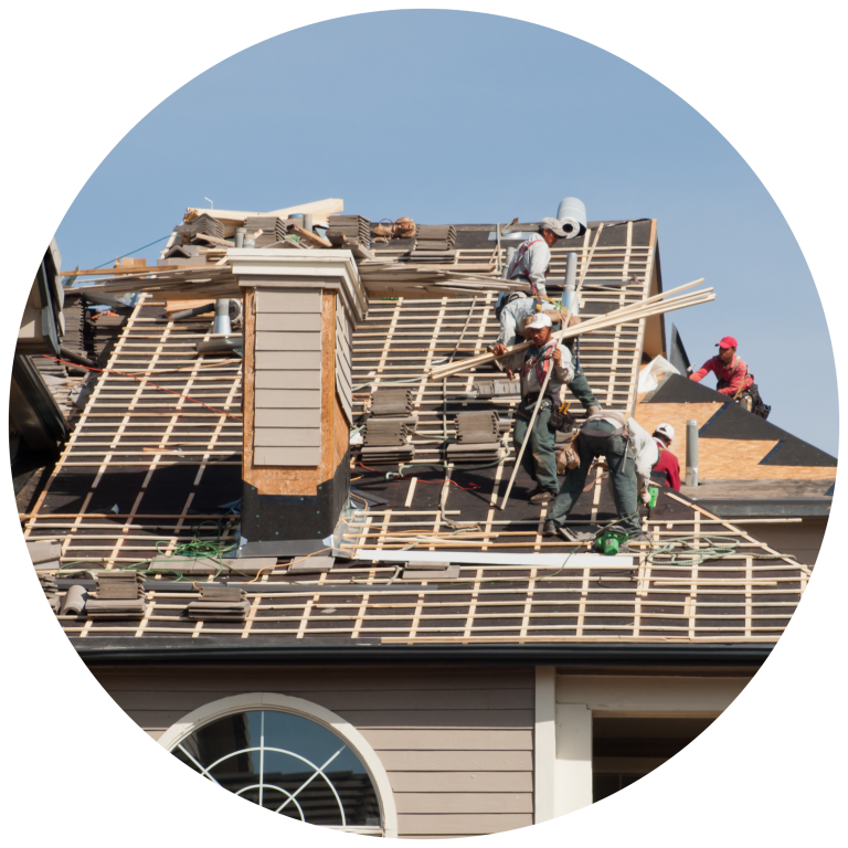 Roof installation team at work on the top of the house